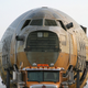 Illustration for article titled Boeing C-17 Fuselage Trucked Through Long Beach Streets In Dead Of Night